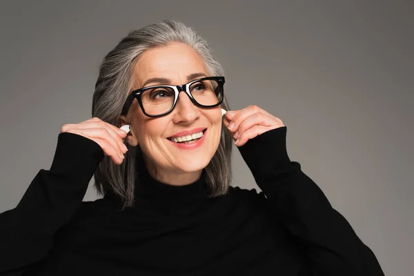 Smiling Mature Woman Holding Earphones Isolated Grey — Stock Photo, Image