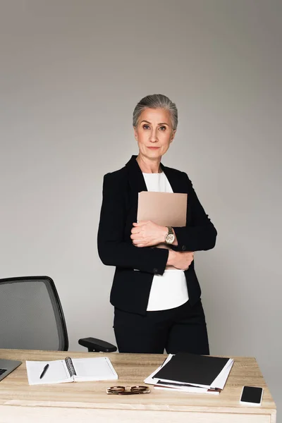 Businesswoman Holding Paper Folder Notebook Eyeglasses Table Isolated Grey — Stock Photo, Image