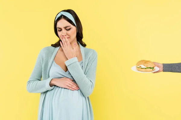 Displeased Pregnant Woman Covering Mouth Hand Burger Isolated Yellow — Stock Photo, Image