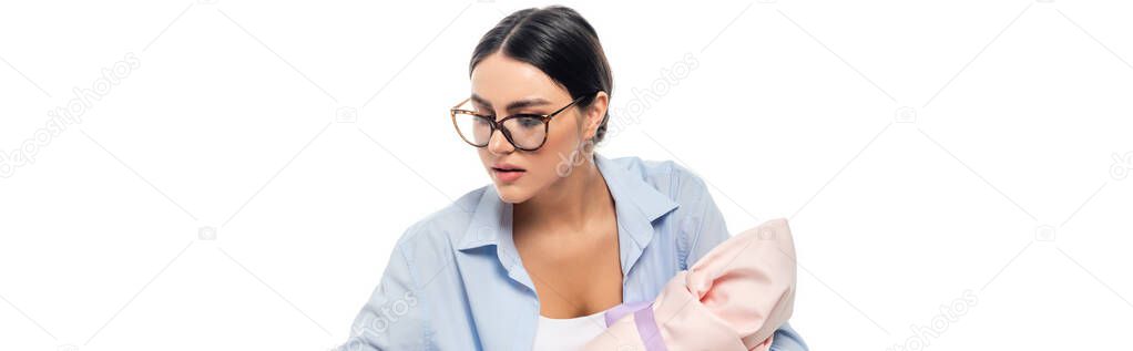 young woman in eyeglasses holding infant baby isolated on white, banner