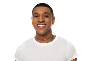 african american man in rainbow colors beads smiling at camera isolated on white, lgbt concept clipart