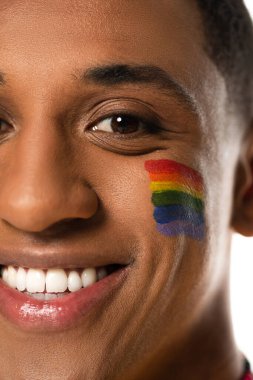 close up view of smiling african american man with lgbt flag painted on face isolated on white clipart