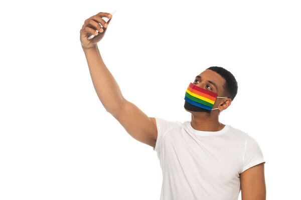 african american man wearing lgbt colors medical mask and taking selfie isolated on white