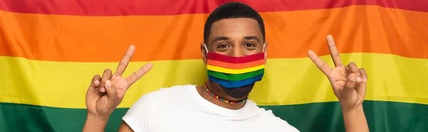 African American Man Rainbow Colors Medical Mask Showing Victory Gesture — Stock Photo, Image