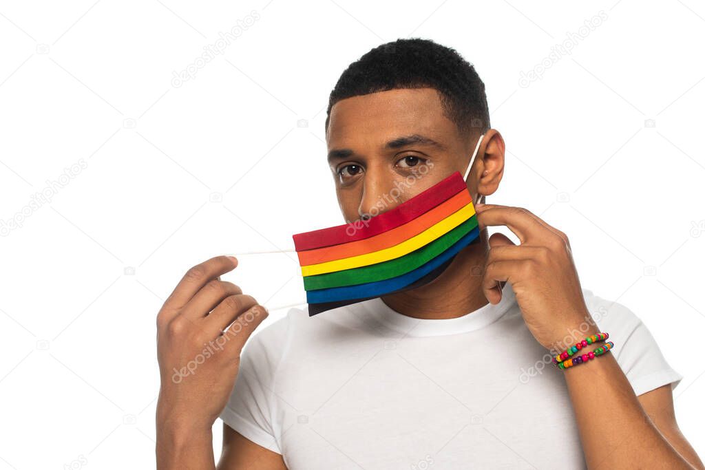 african american man with beads bracelet and safety mask in lgbt colors looking at camera isolated on white