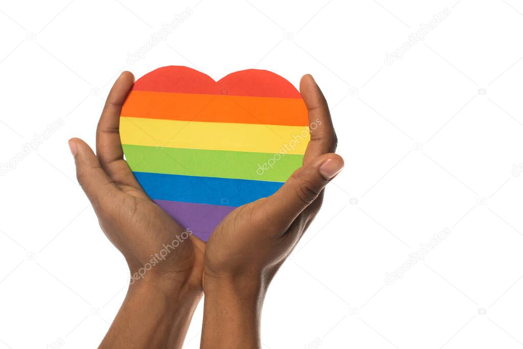 cropped view of african american man with rainbow colors paper heart isolated on white, lgbt concept