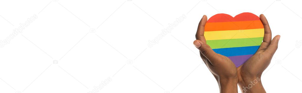 partial view of african american man holding paper heart in lgbt colors isolated on white, banner