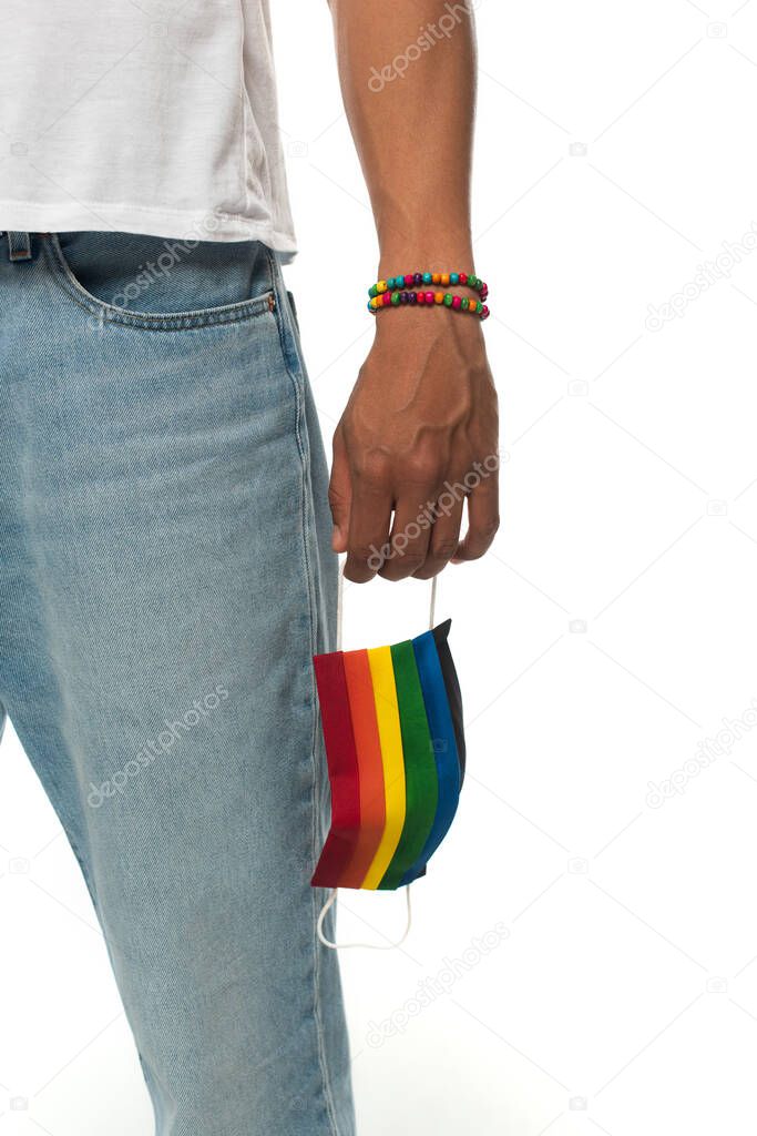 cropped view of african american man with bracelet and medical mask in rainbow colors isolated on white, lgbt concept