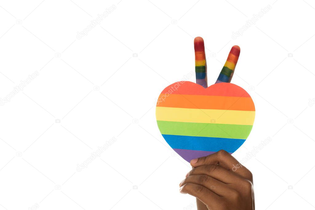 cropped view of african american man showing victory gesture and lgbt colors paper heart isolated on white