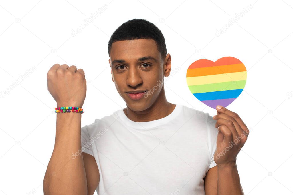 african american man showing beads bracelet and paper heart in lgbt colors isolated on white