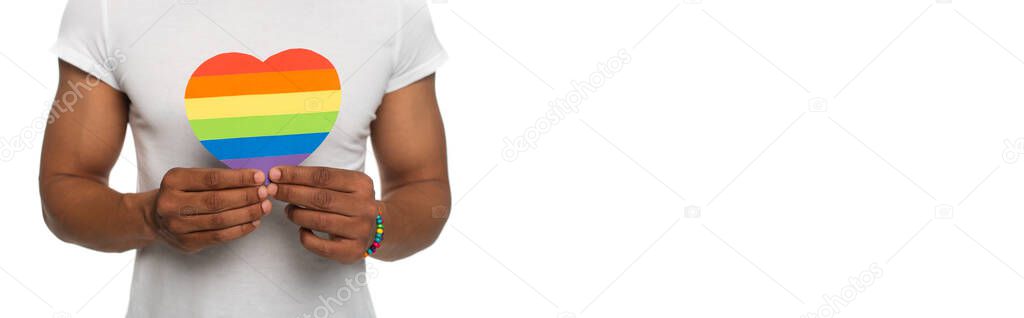 partial view of african american man holding paper heart in lgbt colors isolated on white, banner