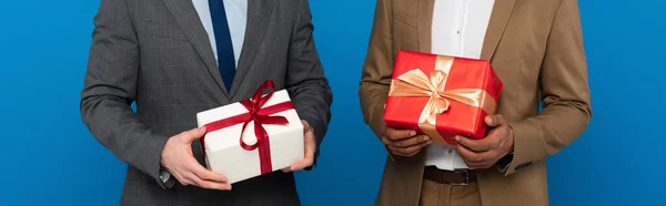 partial crop of men bodies in suits holding gift boxes in hands, banner