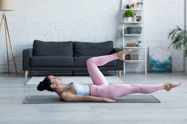 Side View Young Woman Practicing Yoga Wind Removing Pose — Stock Photo, Image