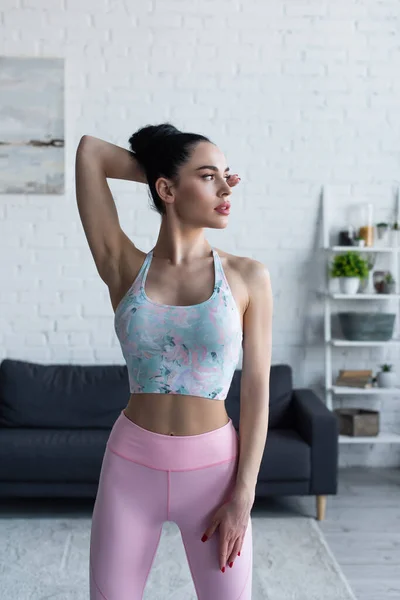 Brunette Woman Sportswear Looking Away While Standing Hand Head — Stock Photo, Image