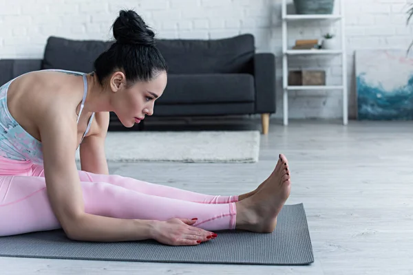 Barefoot Woman Practicing Seated Forward Bend Pose Home — Stock Photo, Image