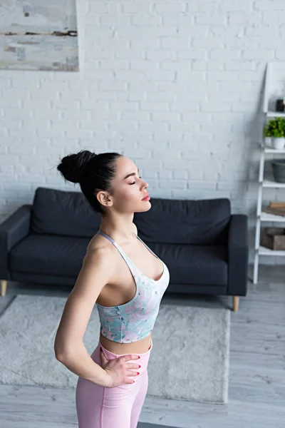 Young Woman Sports Bra Standing Hands Hips Closed Eyes While — Stock Photo, Image