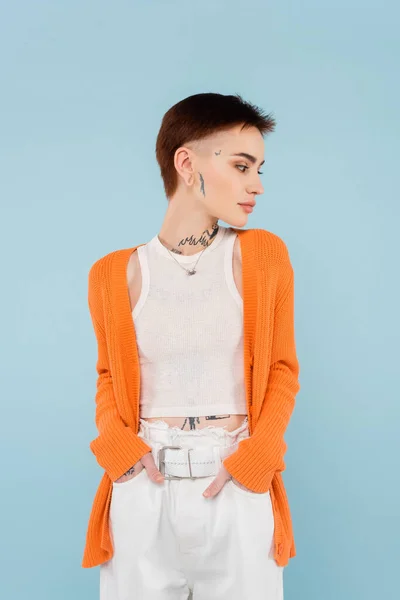 Young Woman Tattoos Orange Cardigan Posing Hands Pockets Isolated Blue — Stock Photo, Image
