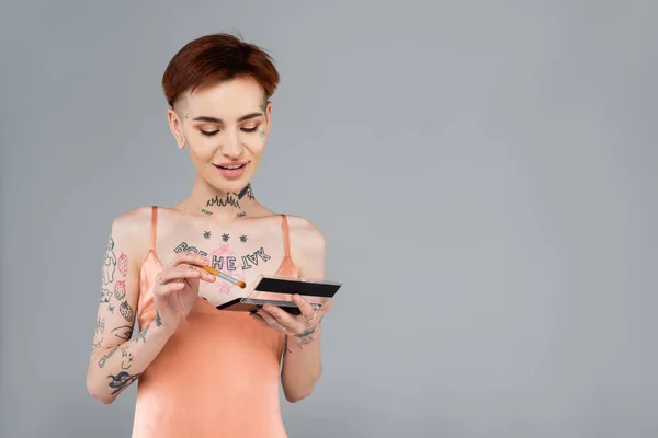 Happy Young Young Tattooed Woman Holding Eye Shadow Palette Isolated — Stock Photo, Image