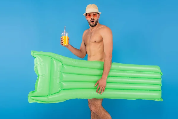 Excited Shirtless Man Holding Orange Juice Inflatable Mattress Isolated Blue — Stock Photo, Image