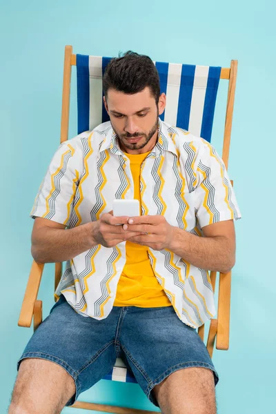 High Angle View Young Man Using Smartphone Deck Chair Blue — Stock Photo, Image