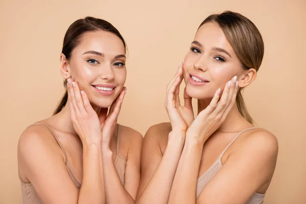 Smiling Women Perfect Skin Touching Faces Isolated Beige — Stock Photo, Image