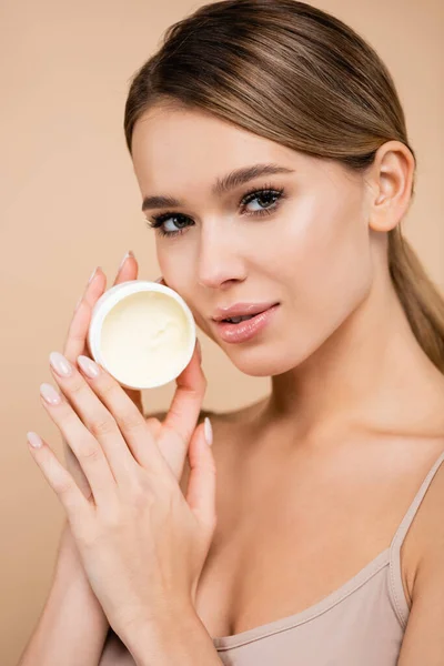 Sensual Woman Holding Cosmetic Cream While Looking Camera Isolated Beige — Stock Photo, Image