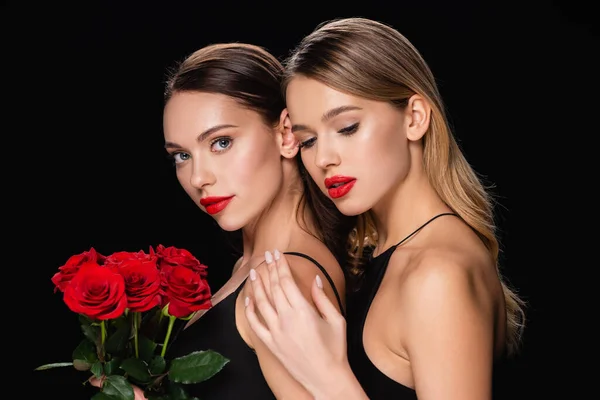 Pretty Woman Touching Shoulder Charming Friend Holding Red Roses Isolated — Stock fotografie