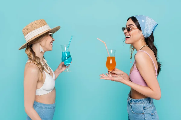 Cheerful Women Sunglasses Holding Cocktails Talking Isolated Blue — Stock Photo, Image