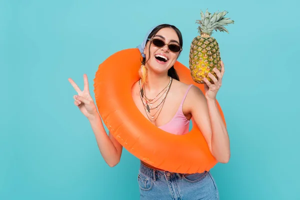 Positive Woman Swim Ring Holding Pineapple Showing Peace Sign Isolated — Stock Photo, Image