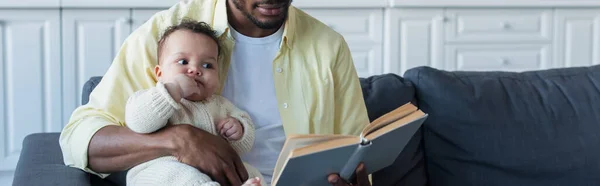 African American Man Reading Book Infant Daughter Banner — Stock Photo, Image