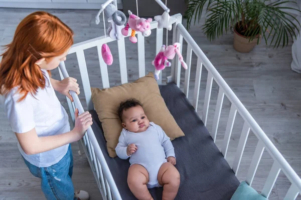 Overhead View Redhead Girl Standing Infant African American Sister Lying — Stock Photo, Image