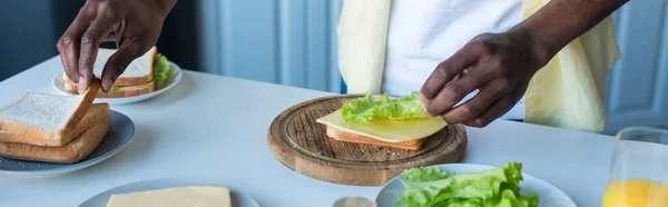 Partial View African American Man Making Sandwiches Cheese Lettuce Banner — Stock Photo, Image