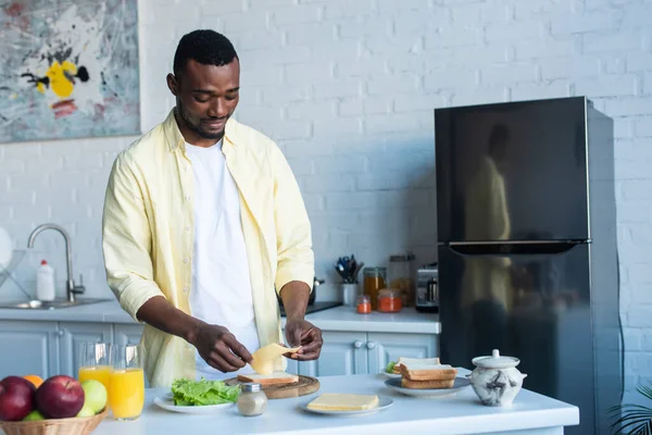 African American Man Making Sandwich Cheese Lettuce Kitchen — Stock Photo, Image