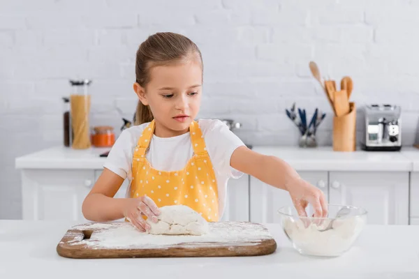 Dziecko Fartuchu Biorąc Mąkę Pobliżu Ciasta Desce Krojenia — Zdjęcie stockowe