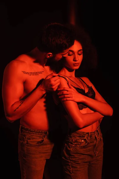 Muscular Man Taking Bra Sensual African American Woman Red Light — Stock Photo, Image
