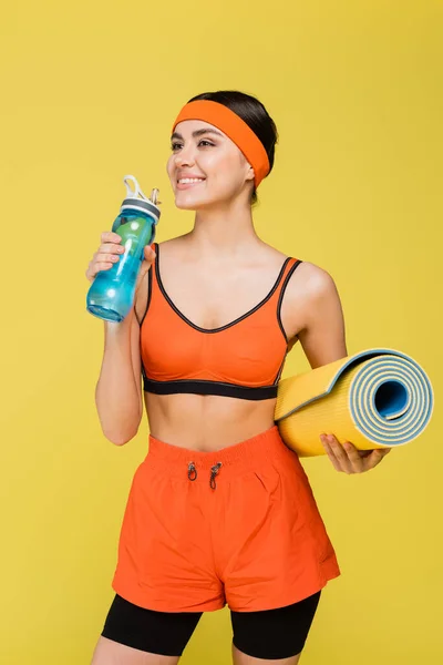 Happy Sportswoman Fitness Mat Drinking Water Sports Bottle Isolated Yellow — Foto de Stock