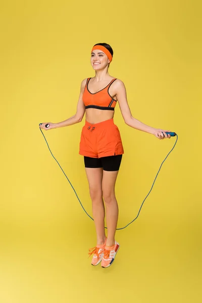 Happy Sportswoman Jumping Skipping Rope Isolated Yellow — Stock Photo, Image