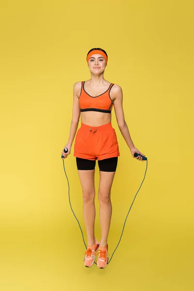 Full Length View Sportive Woman Jumping Skipping Rope Isolated Yellow — 스톡 사진