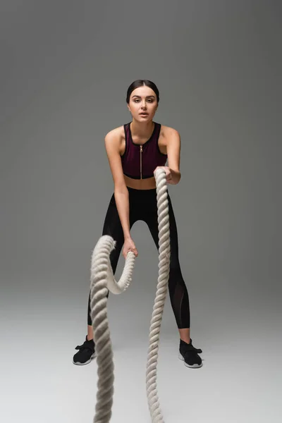 Full Length View Sportive Woman Working Out Battle Ropes Grey —  Fotos de Stock