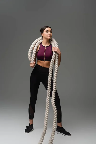 Full Length View Young Sportswoman Holding Battle Ropes Grey Background — 스톡 사진