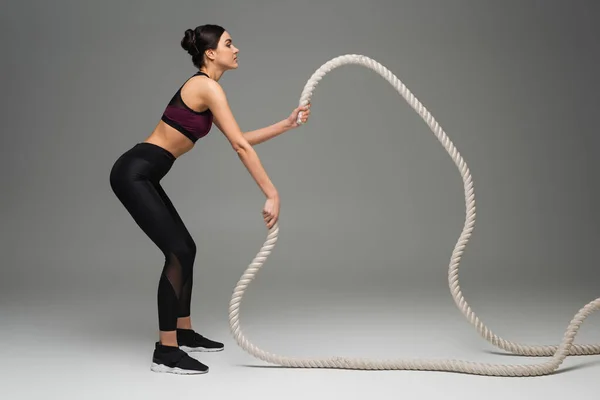 Side View Sportswoman Training Battle Ropes Grey Background — 스톡 사진