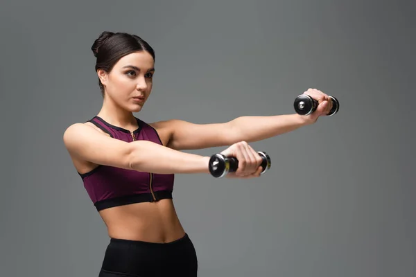 Confident Sportswoman Working Out Dumbbells Isolated Grey — 스톡 사진