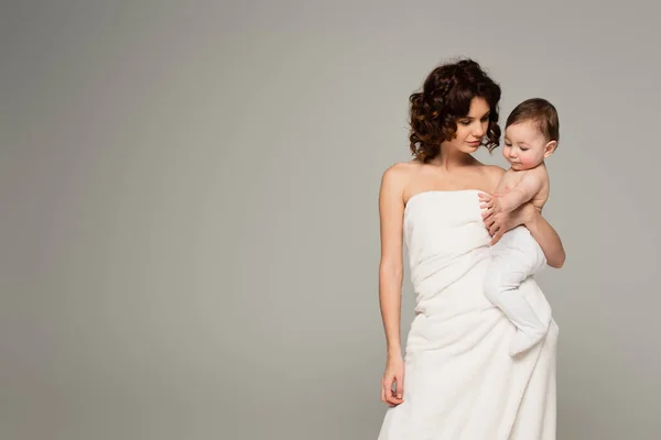 Curly Mother Wrapped Towel Holding Baby Arms Isolated Grey — Stock Photo, Image