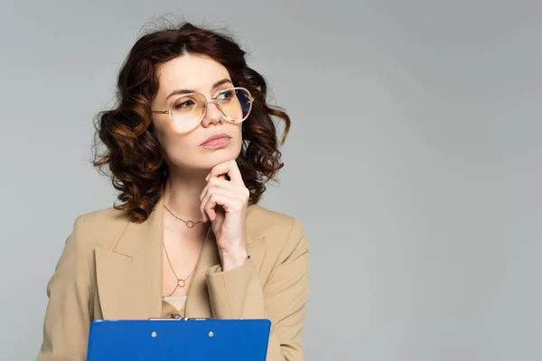 Pensive Young Businesswoman Glasses Blazer Holding Clipboard Isolated Grey — Stock Photo, Image