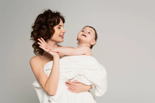 Positive Mother Bare Shoulders Giving High Five Baby Boy Wrapped — Stock Photo, Image