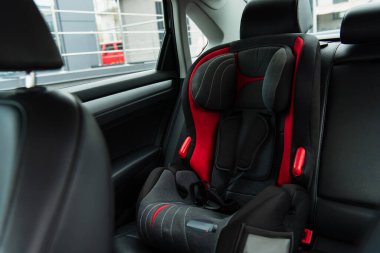 comfortable baby chair inside modern car clipart