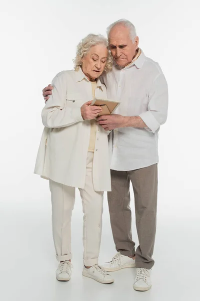 Sad Elderly Couple Casual Clothes Holding Photo Frame Hands White — Stock Photo, Image