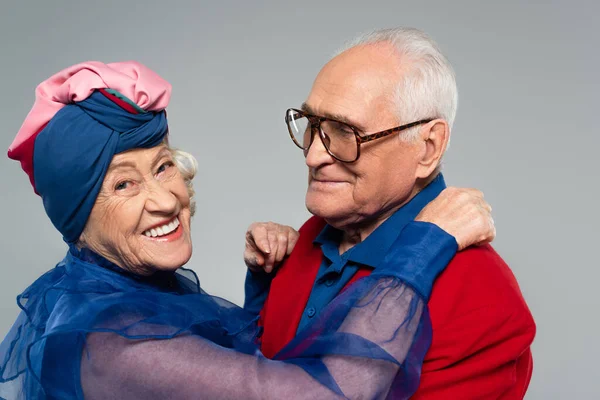 Smiling Elderly Man Red Blazer Hugging Wife Blue Dress Turban — Stock Photo, Image