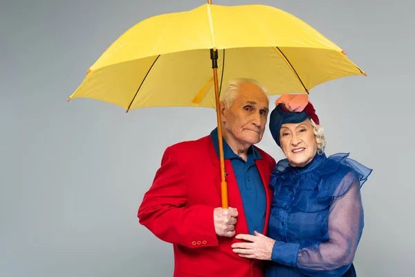 Elderly Man Yellow Umbrella Hugging Wife Blue Dress Turban Isolated — Stock Photo, Image