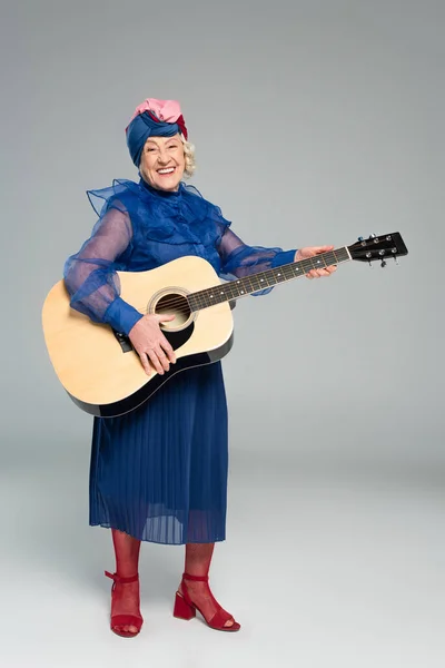 Smiling Elderly Woman Blue Dress Turban Holding Acoustic Guitar Grey — Stock Photo, Image